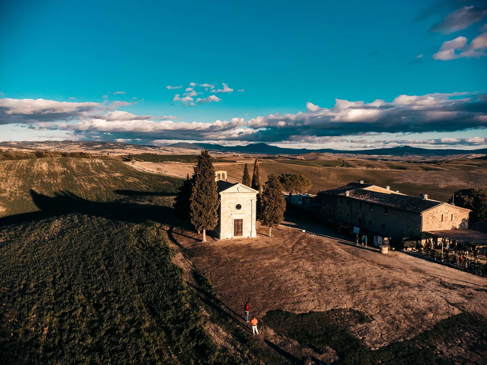 A charming Tuscan hilltop village with terracotta rooftops among green hills in Chianti