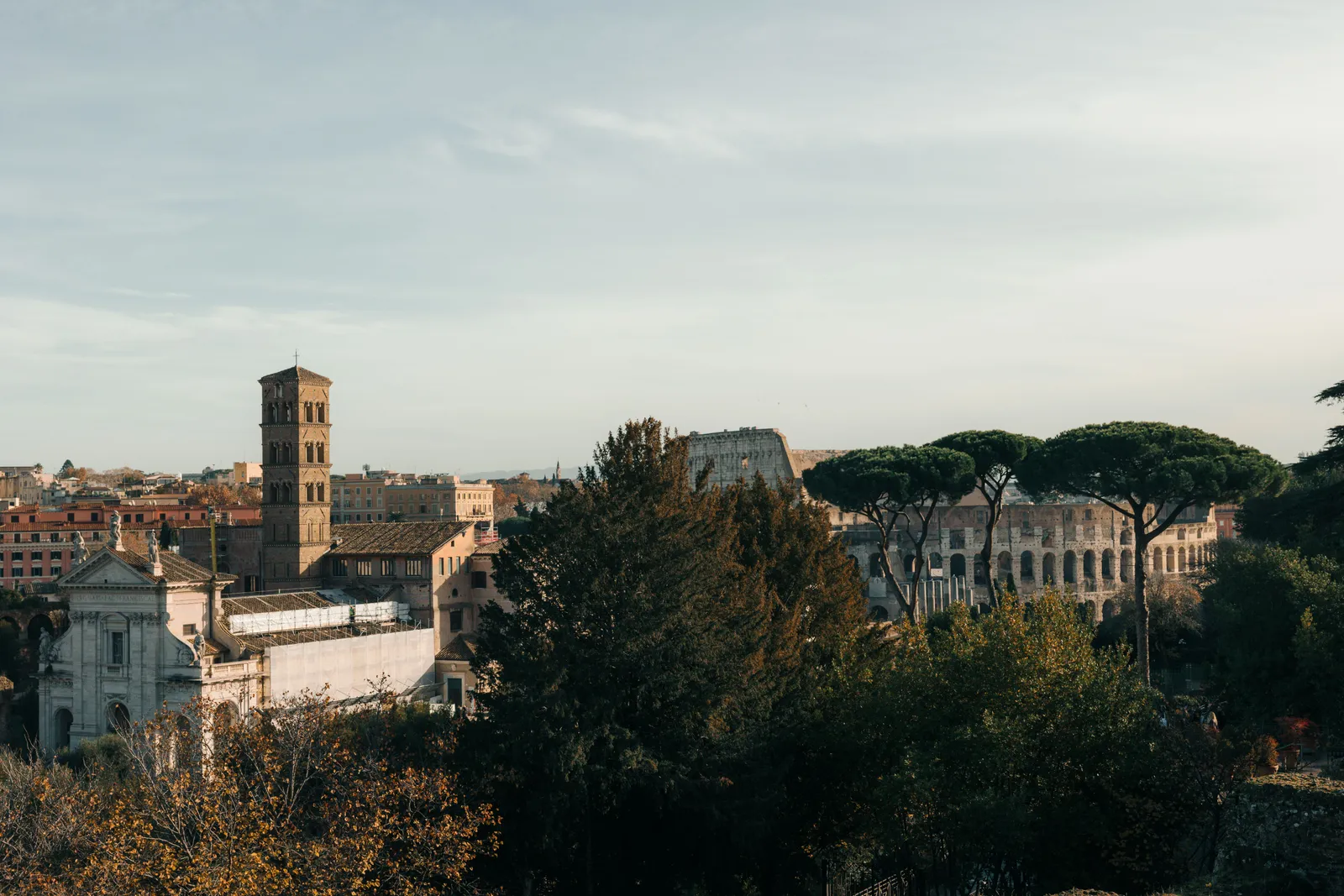 The arches of the Colosseum with the Roman Forum beyond in Rome, Italy