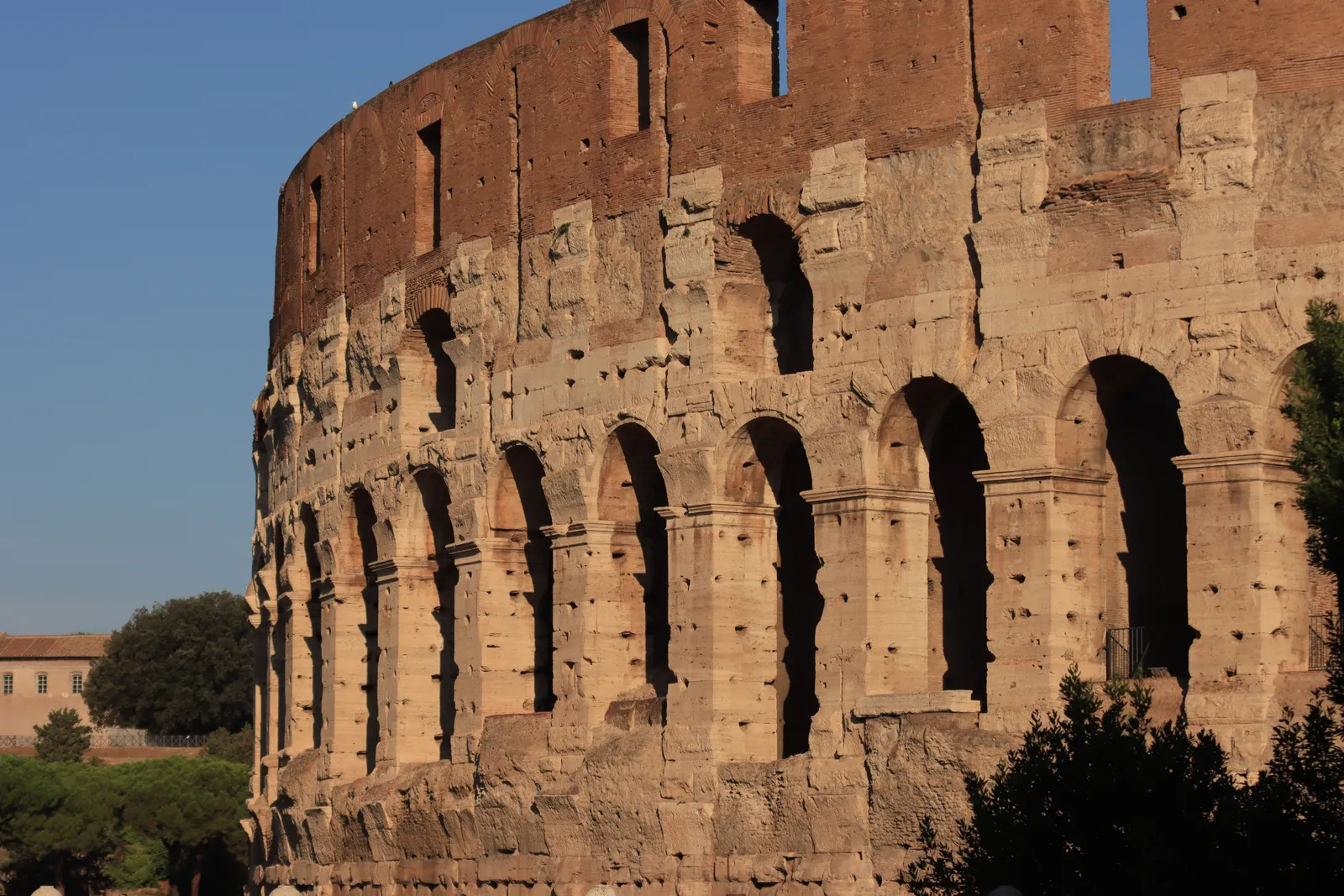 Close view of the tiered stone arches of the Colosseum exterior in Rome, Italy