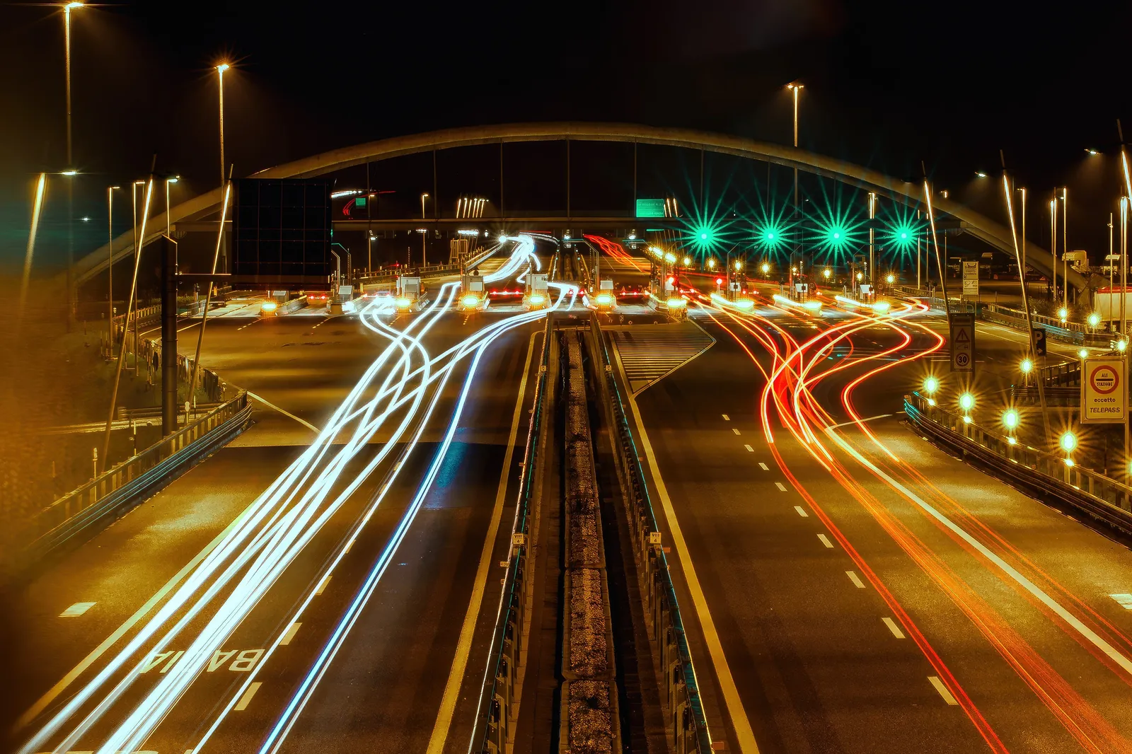 A multi-lane autostrada motorway running through the Italian countryside