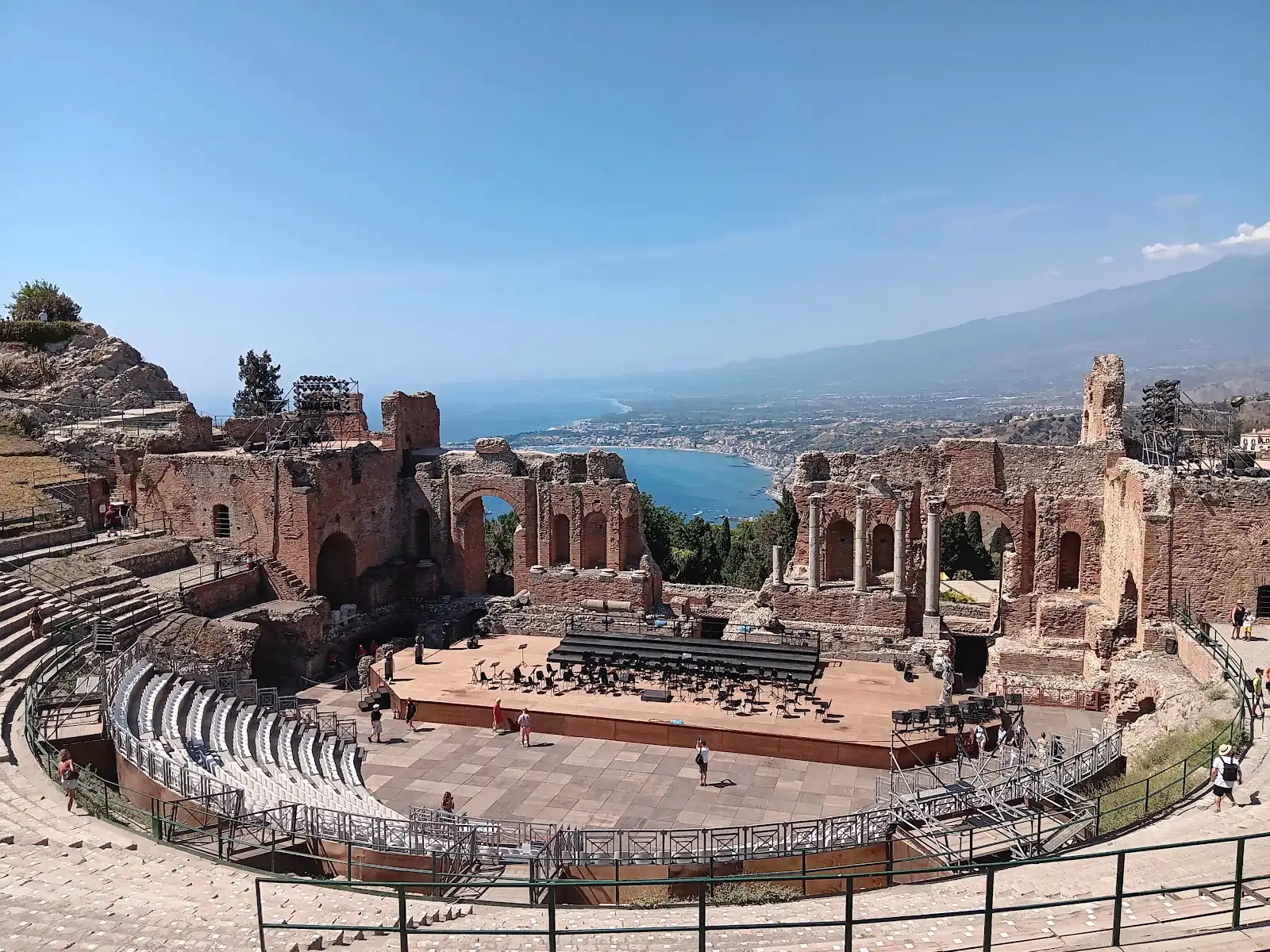 Ancient Greek theatre of Taormina Italy with Mount Etna framed behind the ruined stage