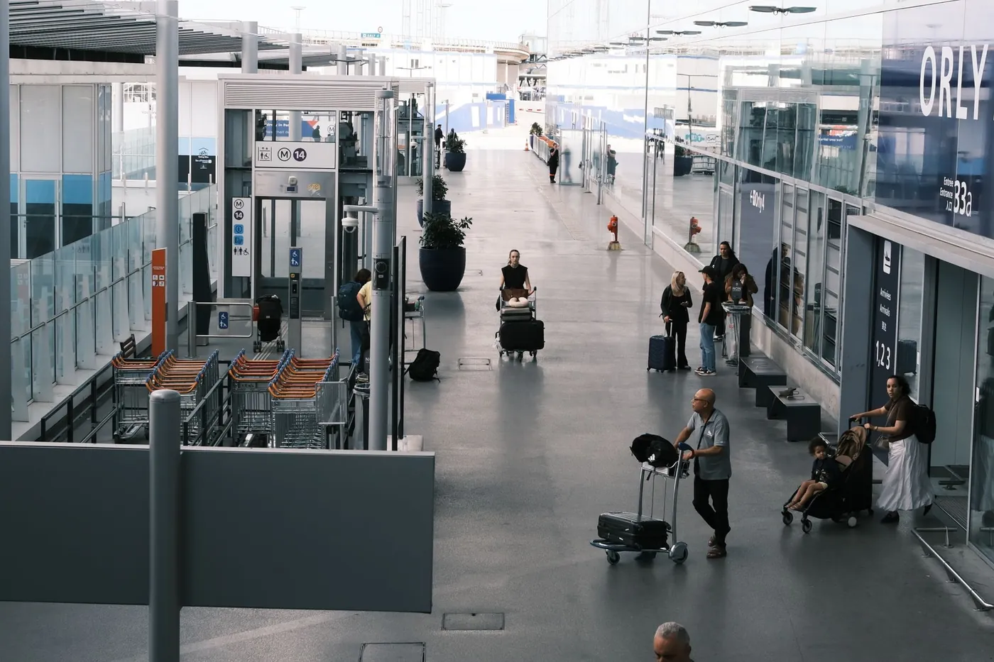 Passengers with luggage carts inside the arrivals terminal at Rome Fiumicino airport in Italy