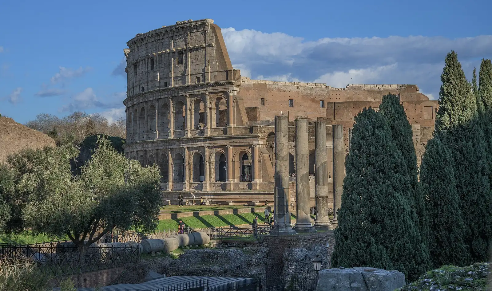 The Colosseum and the columns of the Roman Forum in Rome, Italy, on a clear day